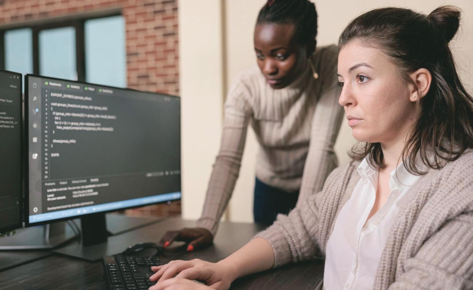 Students working on blockchain development projects in modern computer lab