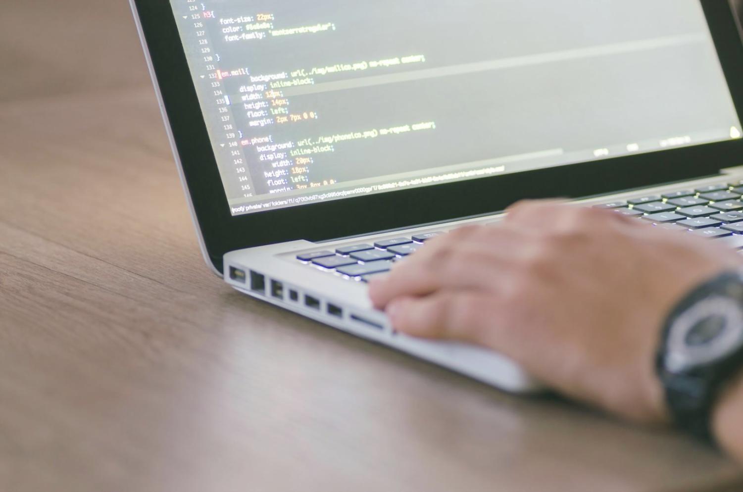 Students working collaboratively on blockchain development projects in a modern learning environment