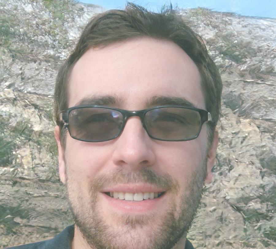 Professional headshot of blockchain education expert